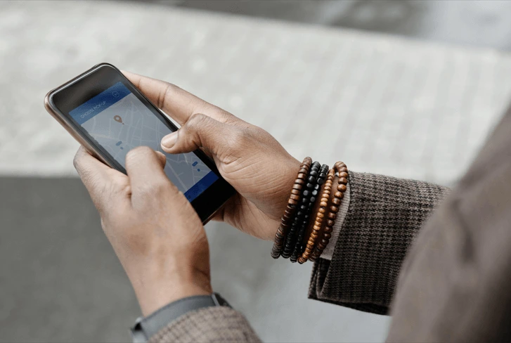 person holding a phone with a real-time navigation assistant app open