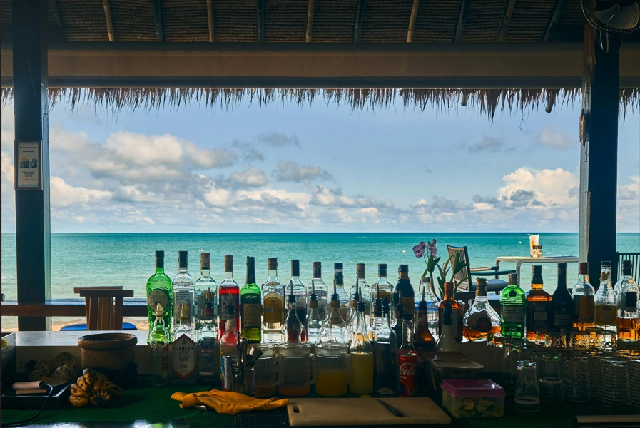 view from behind a beach bar onto the ocean