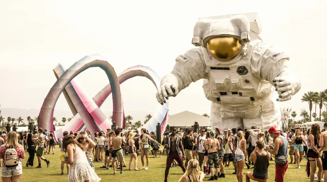 Coachella Festival grounds with inflatable sculptures and many attendees