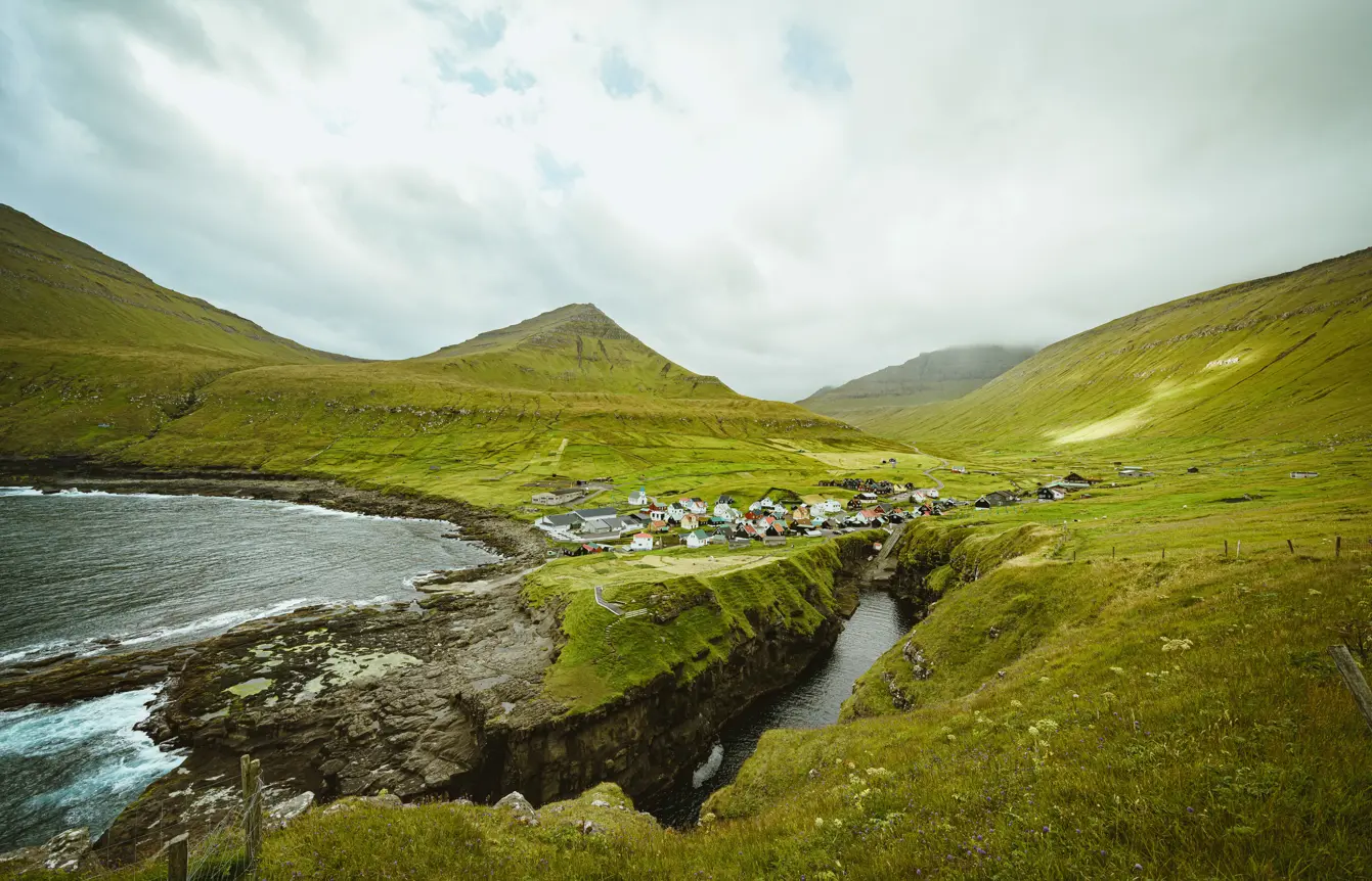 Valley at Faroe Islands with lush green hills