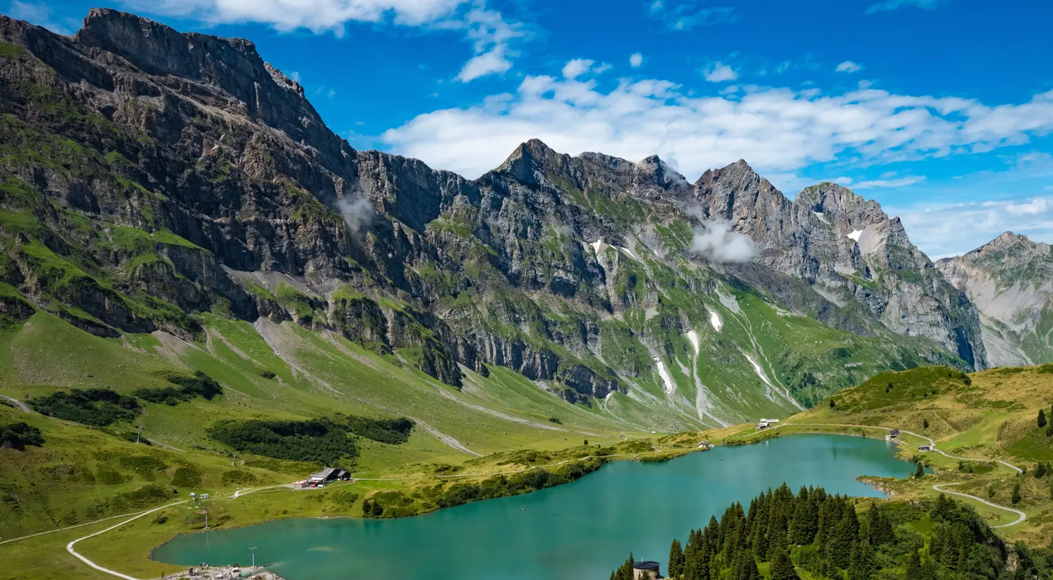 blue lake with mountains in the background in Switzerland