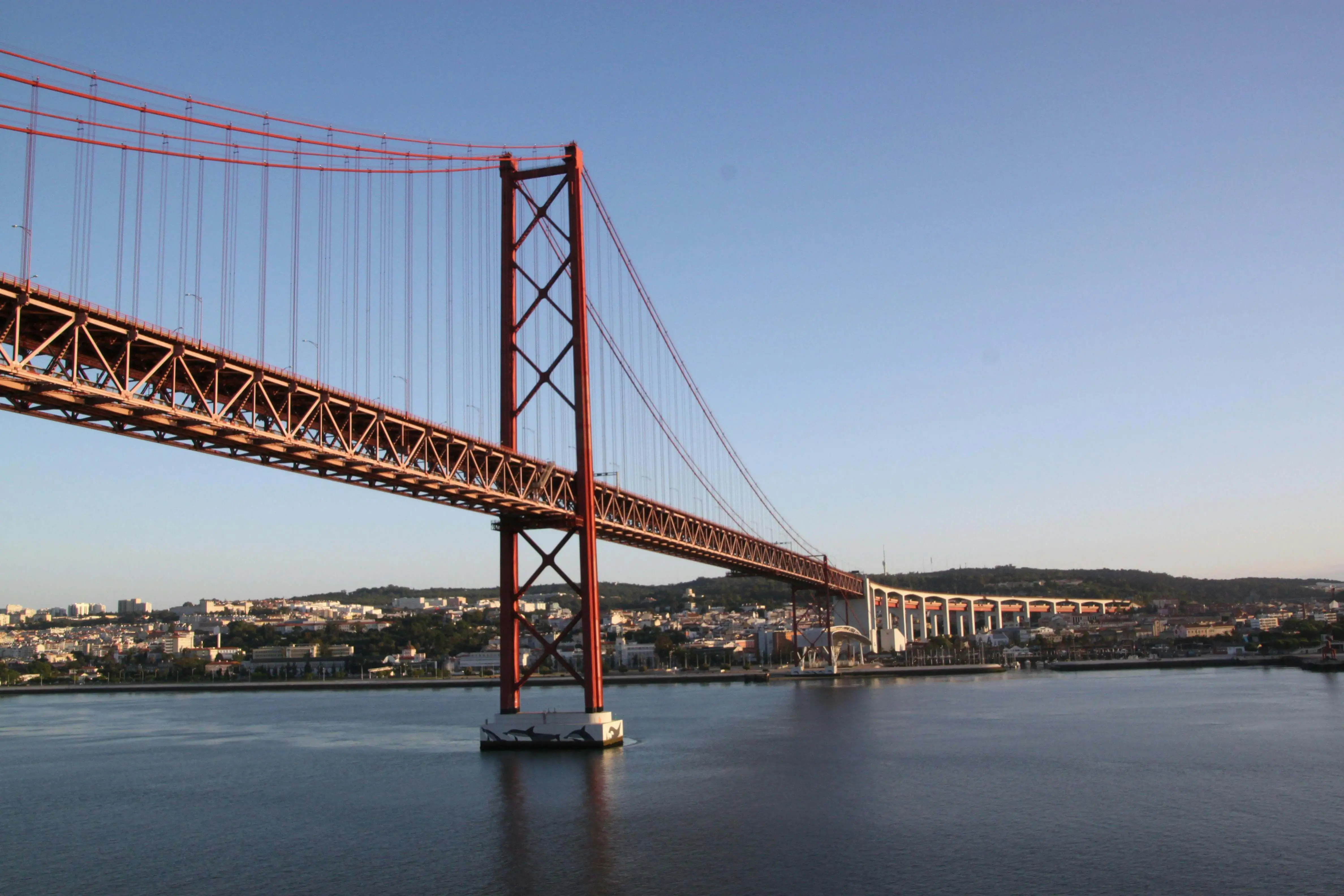 famous bridge in Lisbon during a sunny day with blue skies