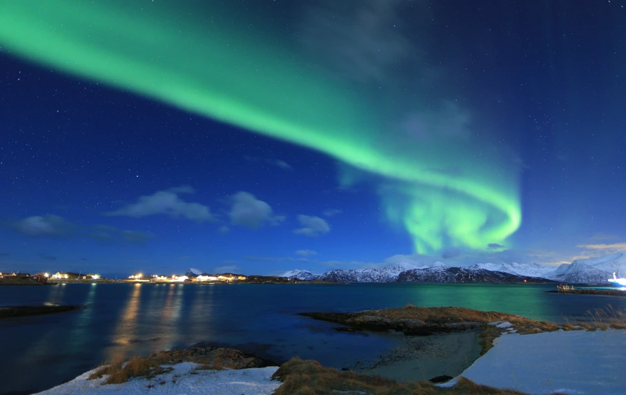 Northern lights shining above the sea in Norway