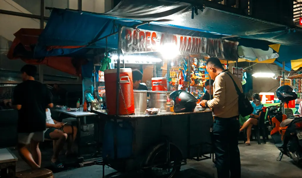 dimly lit street food stall in the Philippines
